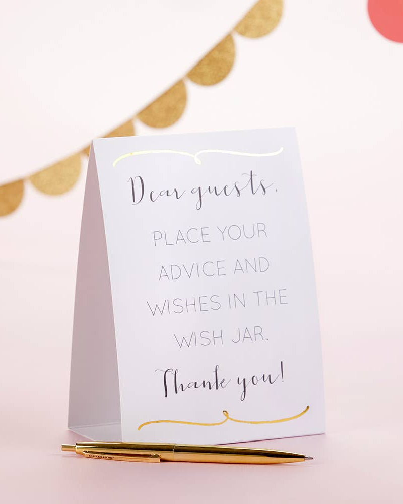 White card with text on a pink background with gold accents