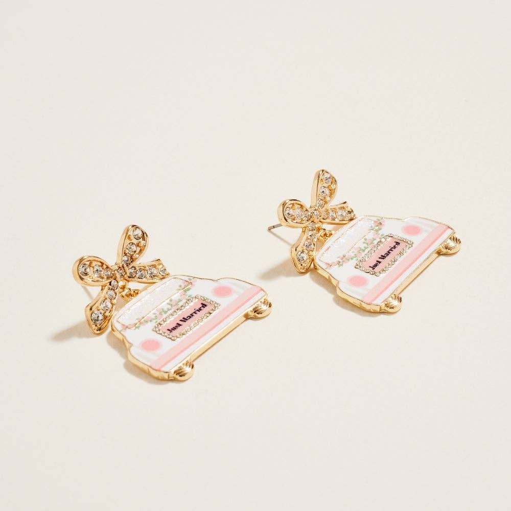 Pair of earrings with pink and gold design on a beige background