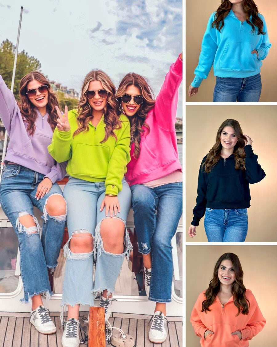 a cropped hooded quarter zip pullover with a relaxed fit, functional kangaroo pocket, and thumb holes in aqua, black, coral, lavender, neon lime, and pink