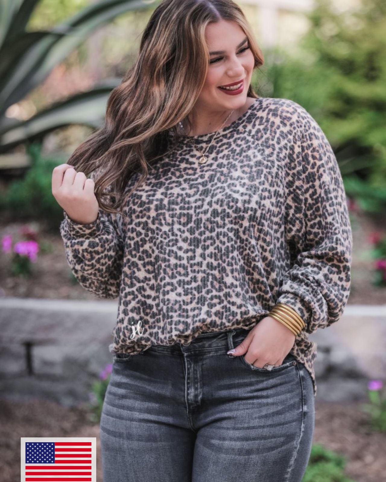 MADE IN USA long-sleeve top crafted from soft material with a waffle knit texturing, a round neckline, and a relaxed silhouette that falls into a split hi low rounded hemline on a black leopard pattern fabric and a tan base
