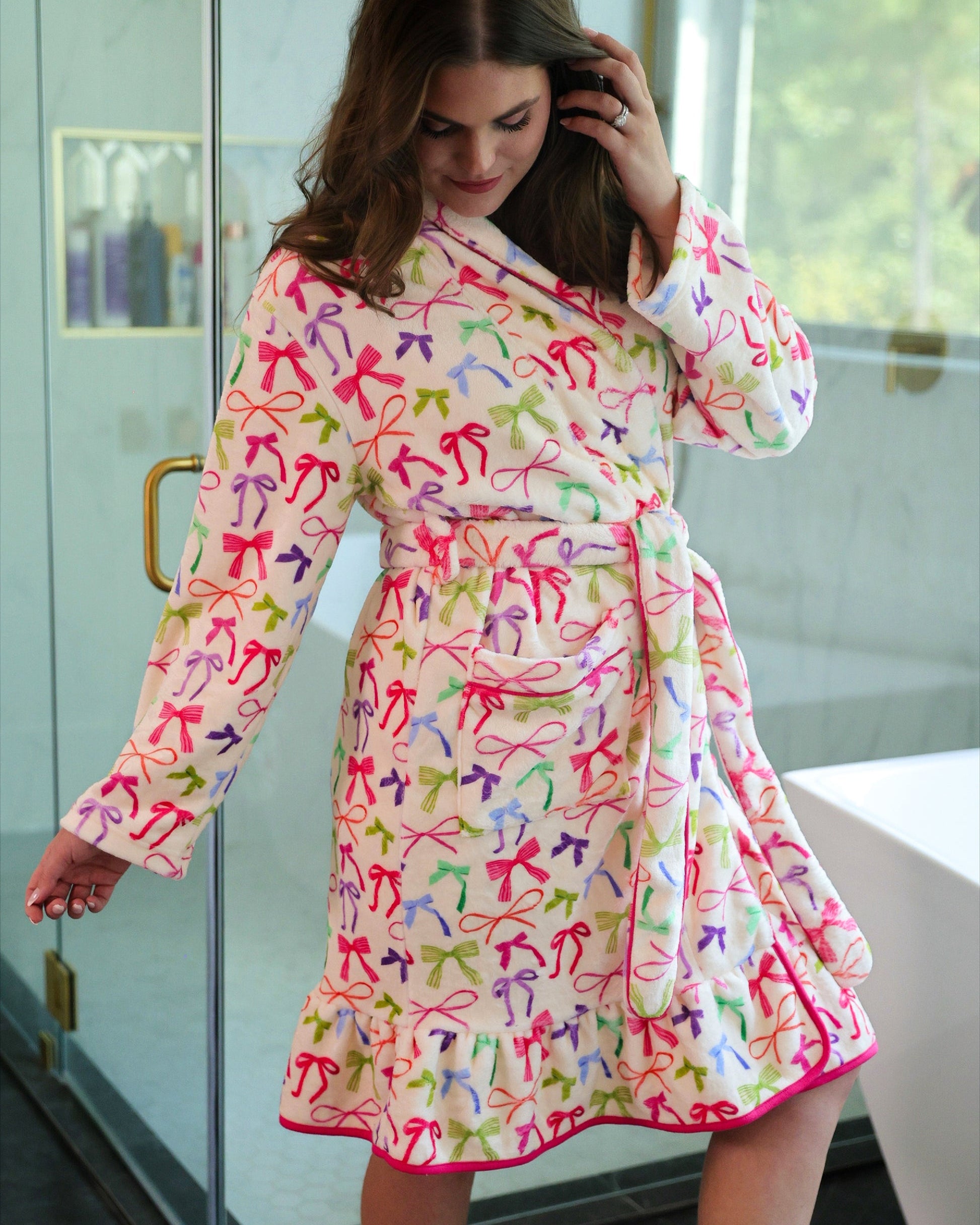 a long sleeve robe with a flattering wrap silhouette, an adjustable waist tie, a playful ruffle hem, and deep patch pockets on ultra plush fabric in Daylight Bow (Multi)