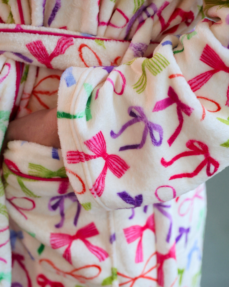 a long sleeve robe with a flattering wrap silhouette, an adjustable waist tie, a playful ruffle hem, and deep patch pockets on ultra plush fabric in Daylight Bow (Multi)
