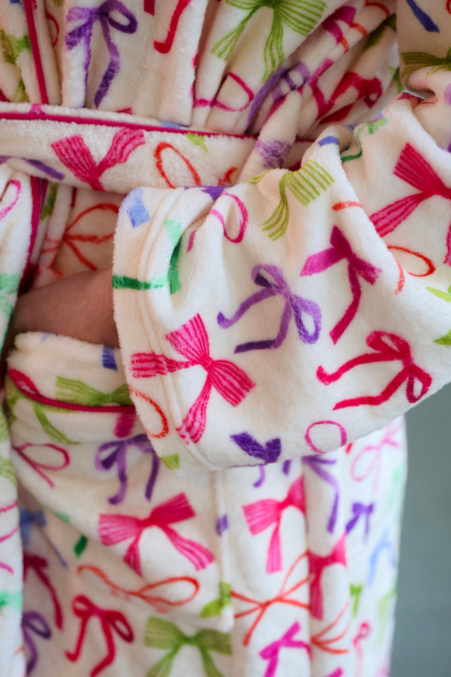 a long sleeve robe with a flattering wrap silhouette, an adjustable waist tie, a playful ruffle hem, and deep patch pockets on ultra plush fabric in Daylight Bow (Multi)