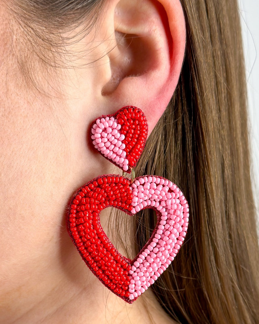 two-toned mirrored heart-shaped dangle earrings with a comfort back and a plastic disc stopper in gold