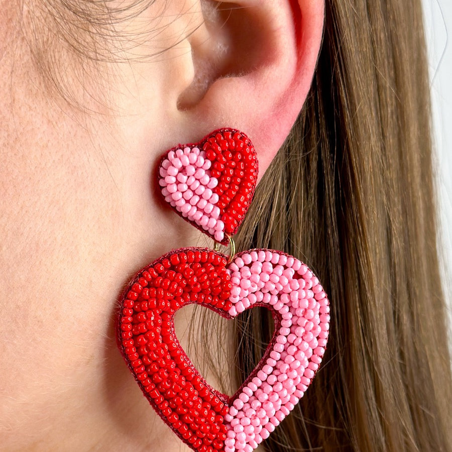 two-toned mirrored heart-shaped dangle earrings with a comfort back and a plastic disc stopper in gold