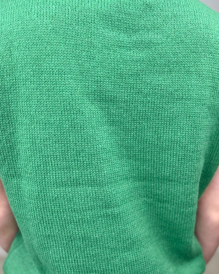 a green soft knit sleeveless seater vest with shimmering 'Lucky' lettering, a relaxed fit, and ribbed collar, cuffs, and hem