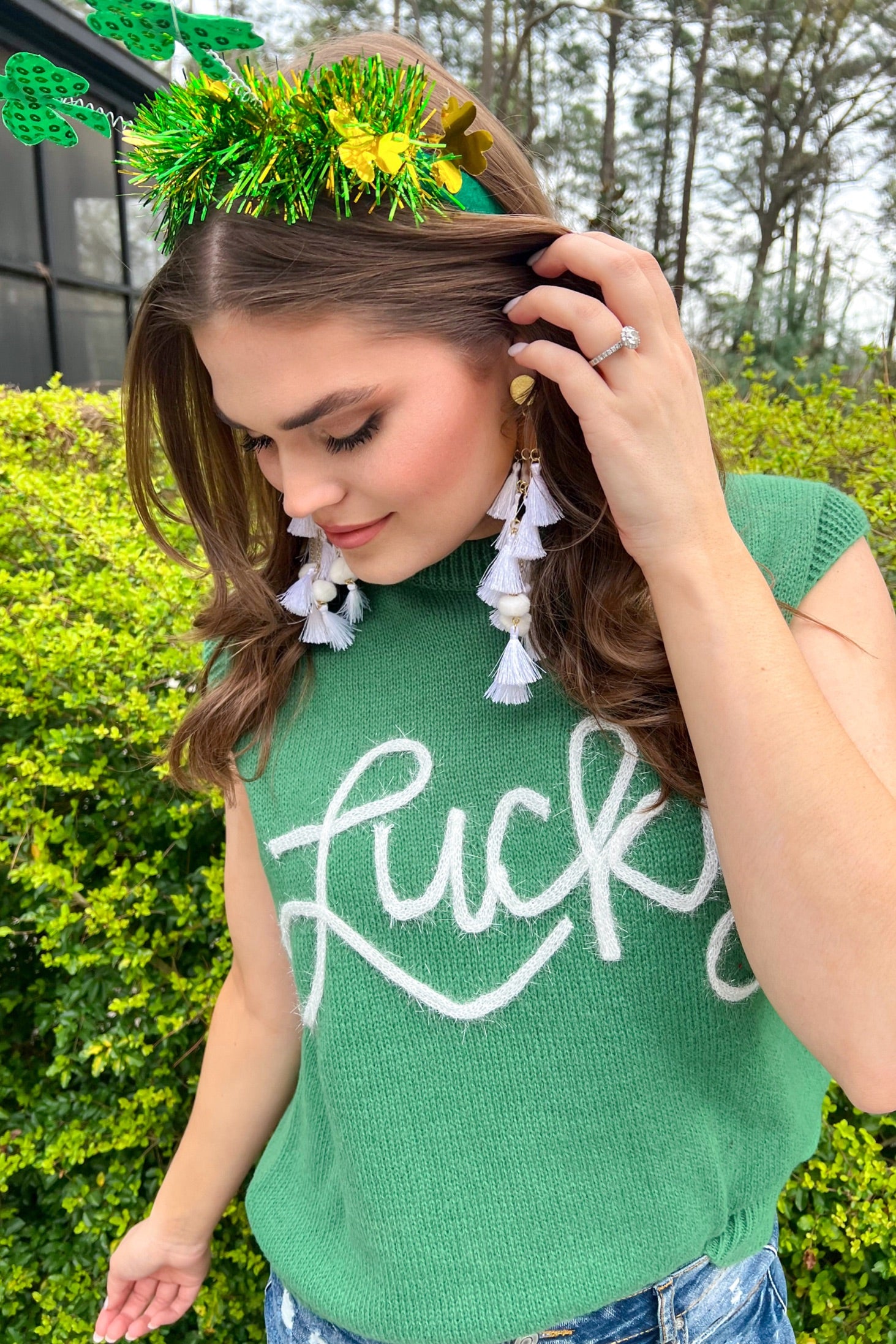a green soft knit sleeveless seater vest with shimmering 'Lucky' lettering, a relaxed fit, and ribbed collar, cuffs, and hem