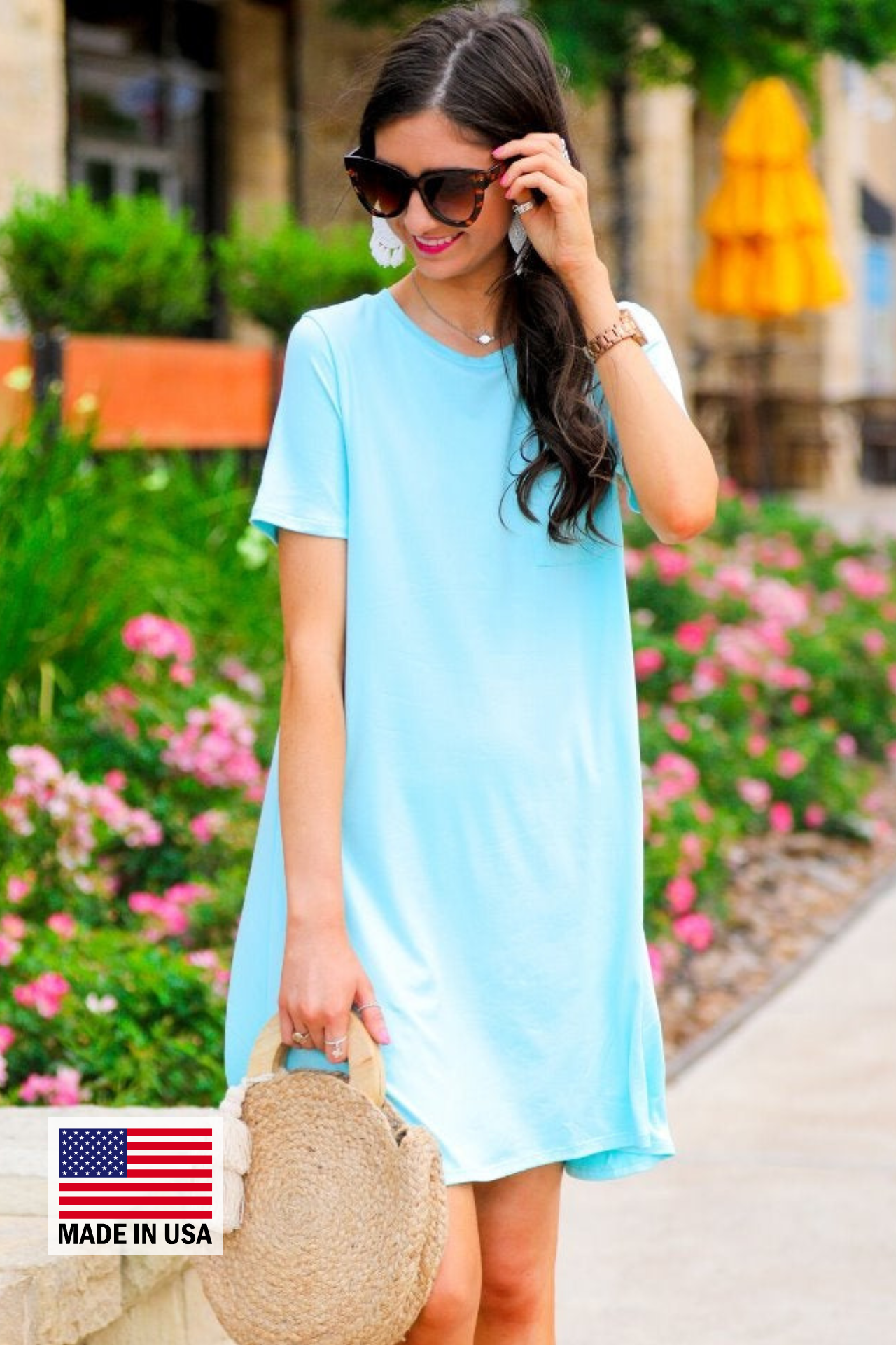 an ultra soft aqua T-shirt dress with an easy A-line silhouette, short sleeves, a round neckline, a chest pocket, and a straight hemline with MADE IN USA watermark in the bottom left hand corner