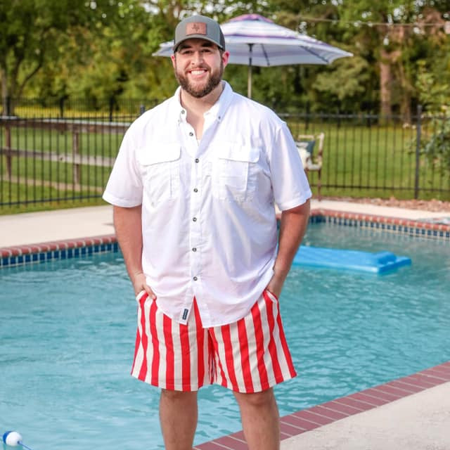 red and white vertical stripe swim trunks with an elastic waistband, drawstring tie, pockets, and built-in mesh underwear