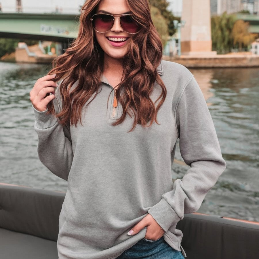 long sleeve pullover crafted from vintage wash fabric with a foldable collar, side slits, and a quarter zip in grey