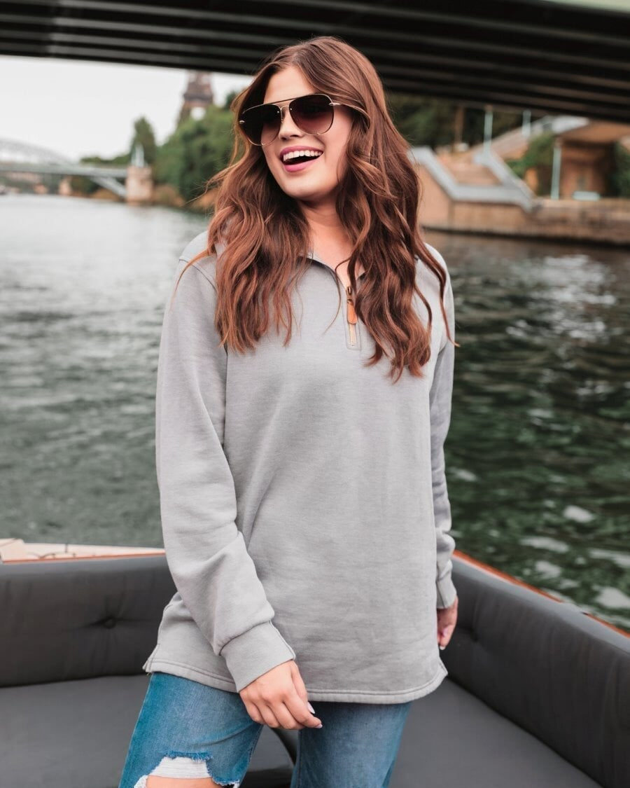 long sleeve pullover crafted from vintage wash fabric with a foldable collar, side slits, and a quarter zip in grey