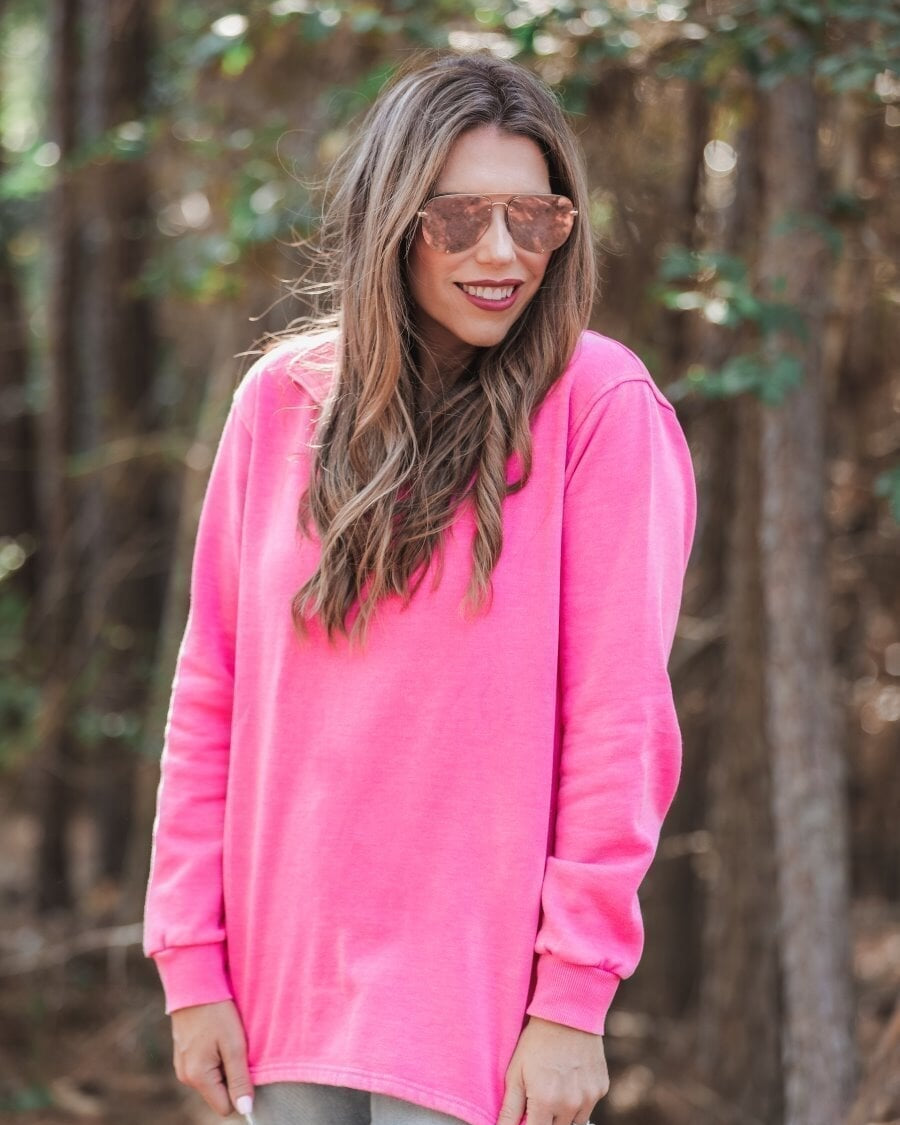 long sleeve pullover crafted from vintage wash fabric with a foldable collar, side slits, and a quarter zip in pink