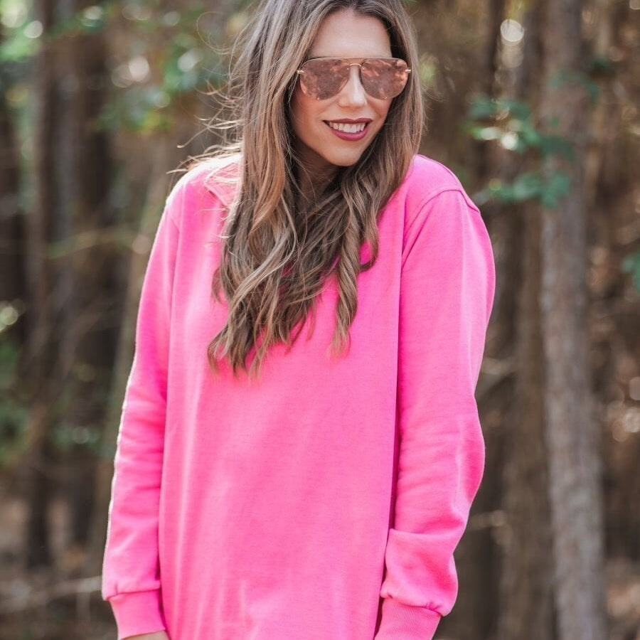 long sleeve pullover crafted from vintage wash fabric with a foldable collar, side slits, and a quarter zip in pink