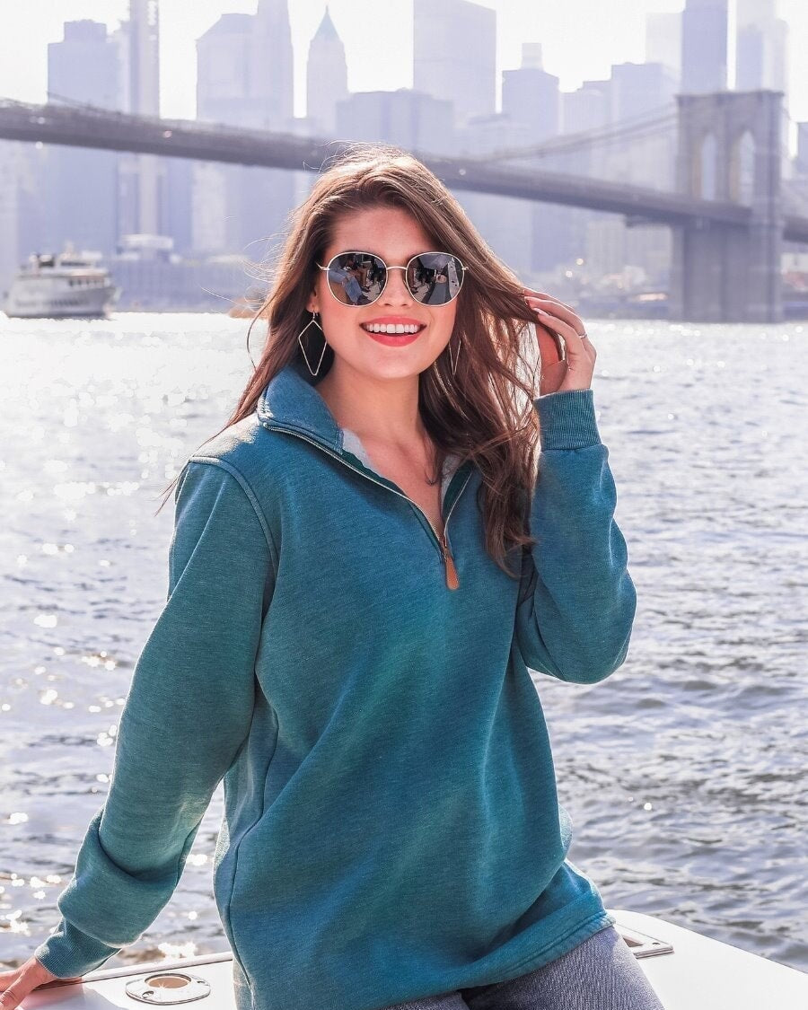 long sleeve pullover crafted from vintage wash fabric with a foldable collar, side slits, and a quarter zip in teal