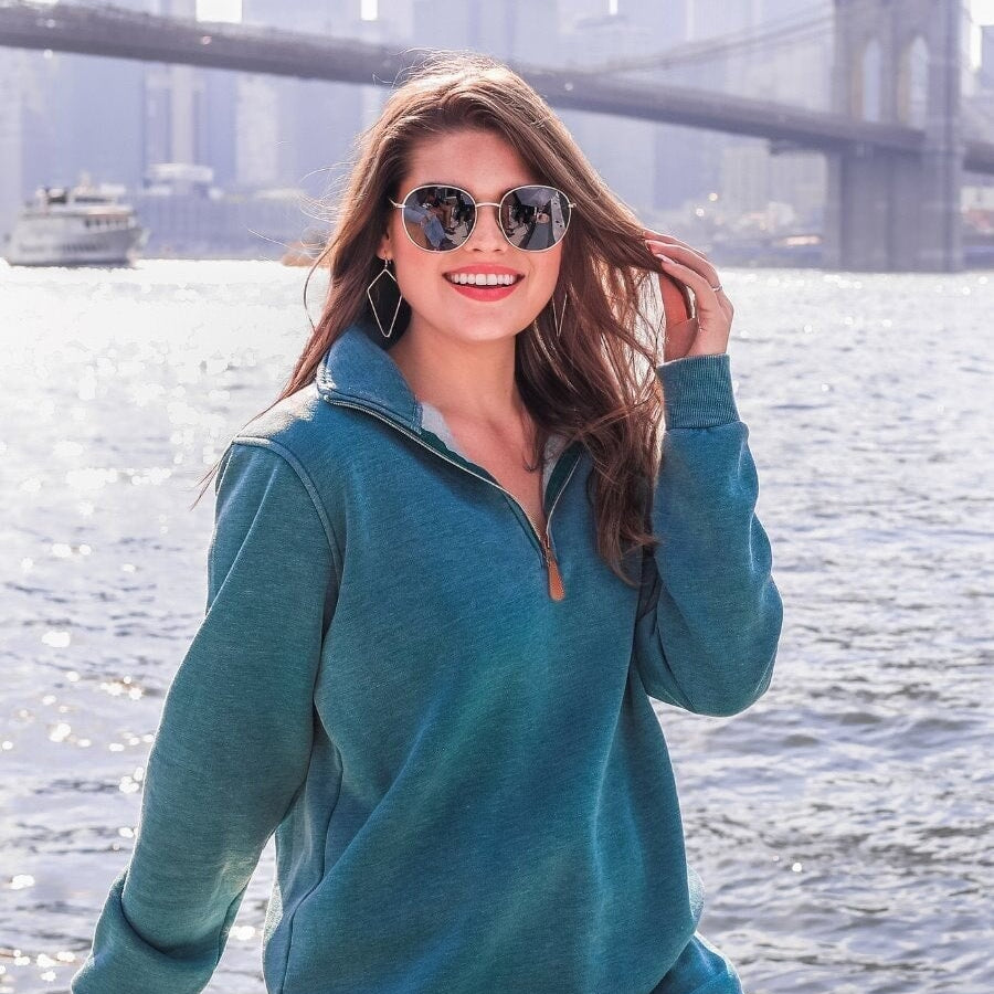 long sleeve pullover crafted from vintage wash fabric with a foldable collar, side slits, and a quarter zip in teal