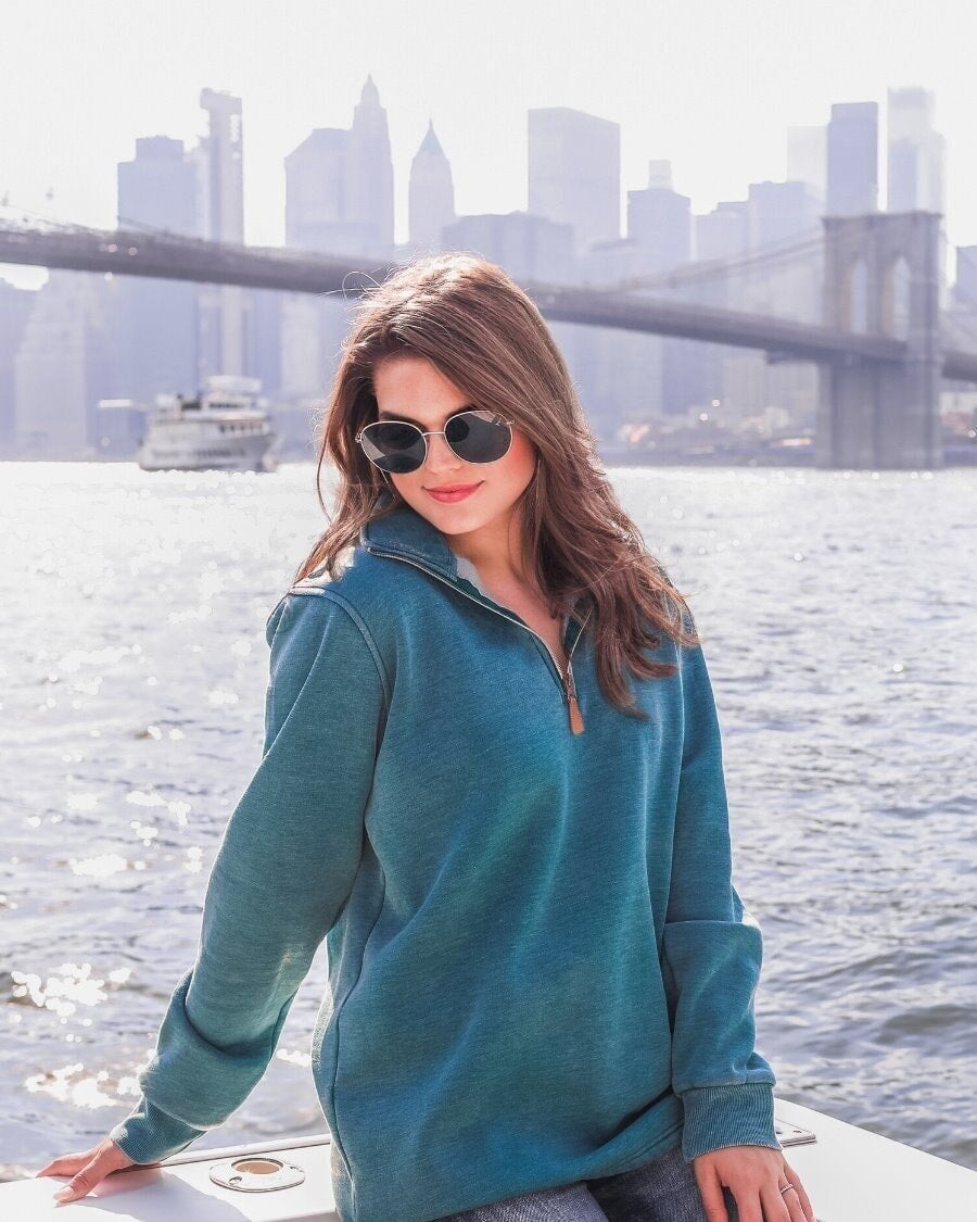 long sleeve pullover crafted from vintage wash fabric with a foldable collar, side slits, and a quarter zip in teal