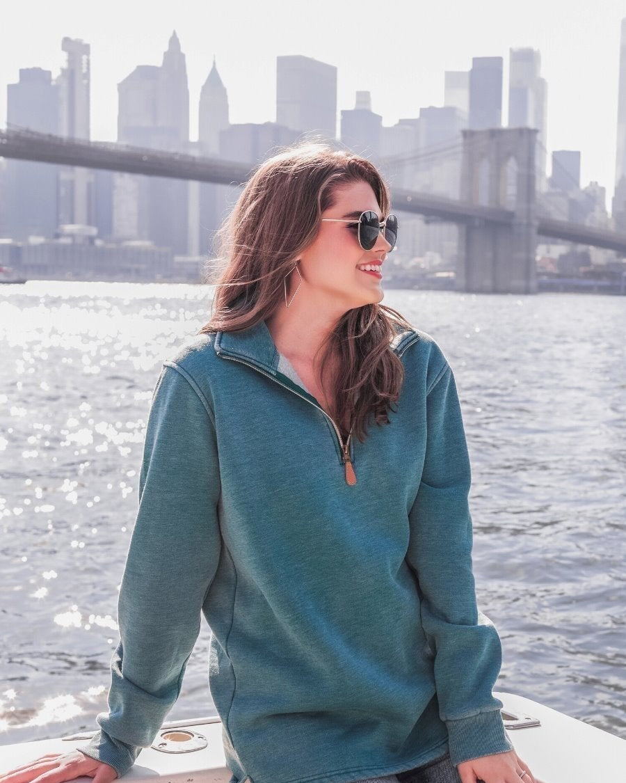 long sleeve pullover crafted from vintage wash fabric with a foldable collar, side slits, and a quarter zip in teal