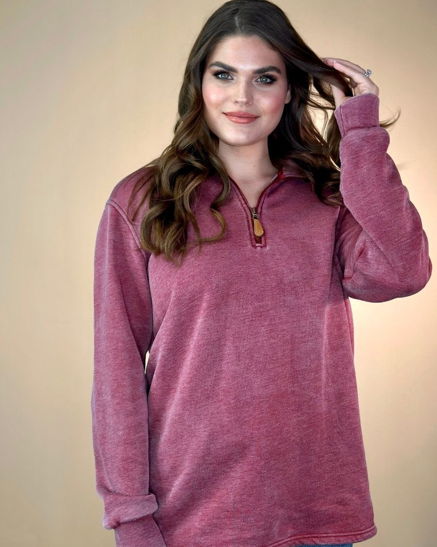 long sleeve pullover crafted from vintage wash fabric with a foldable collar, side slits, and a quarter zip in wine