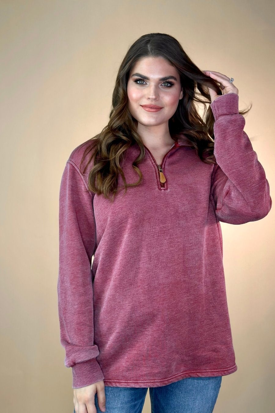 long sleeve pullover crafted from vintage wash fabric with a foldable collar, side slits, and a quarter zip in wine