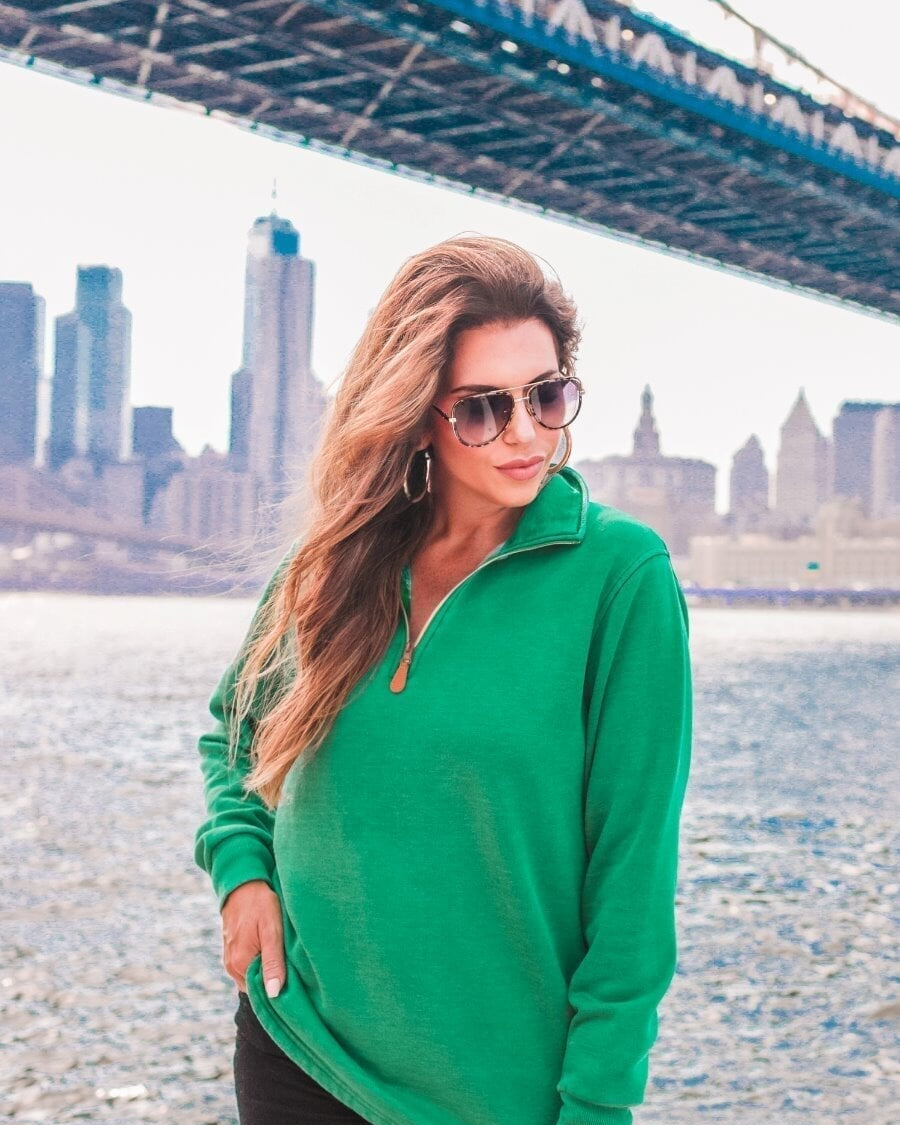 long sleeve pullover crafted from vintage wash fabric with a foldable collar, side slits, and a quarter zip in green