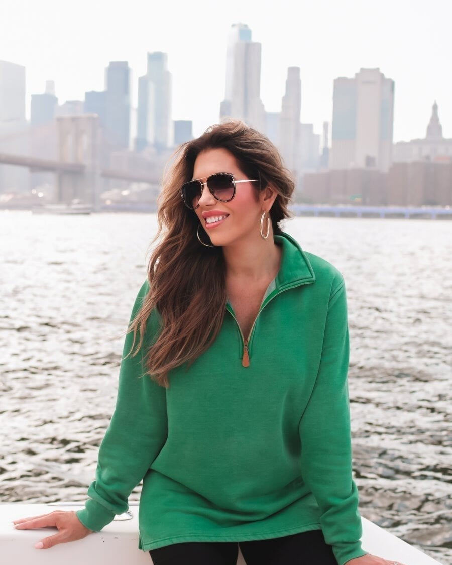 long sleeve pullover crafted from vintage wash fabric with a foldable collar, side slits, and a quarter zip in green