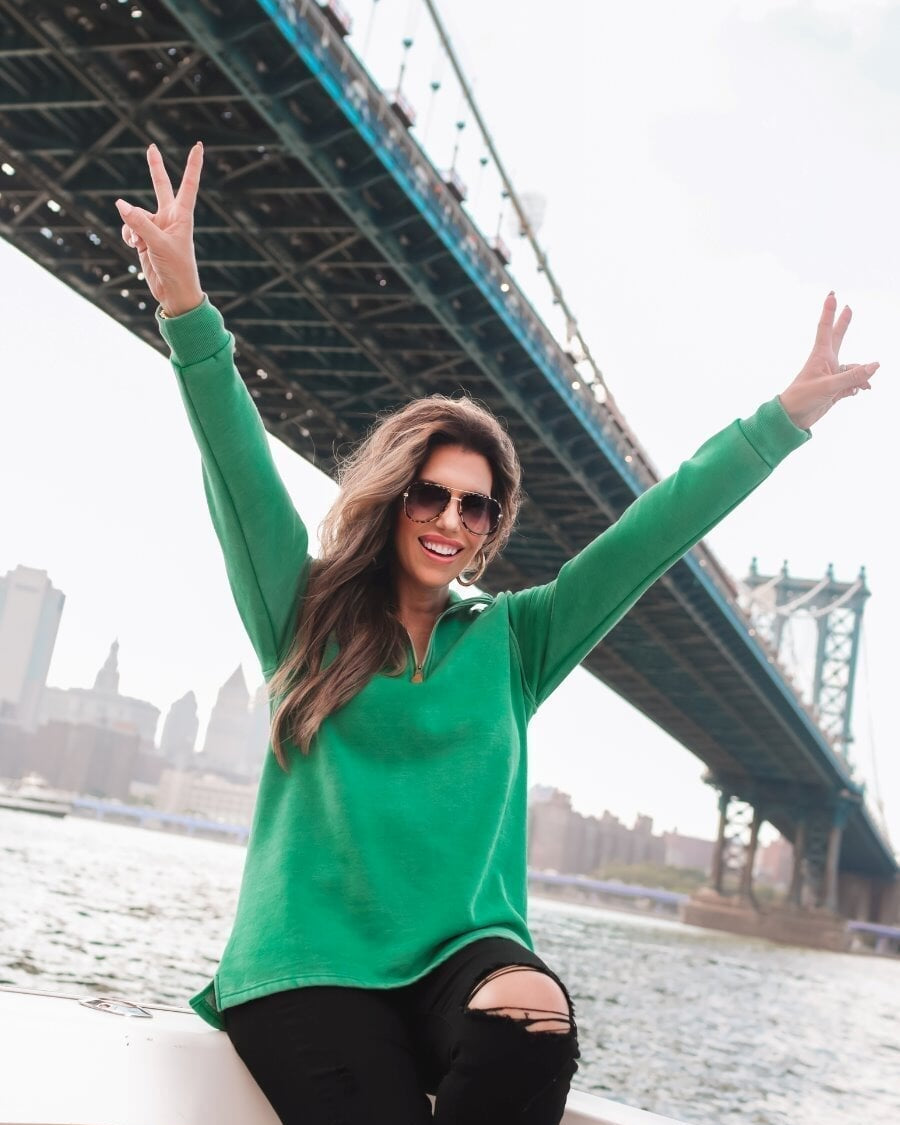 long sleeve pullover crafted from vintage wash fabric with a foldable collar, side slits, and a quarter zip in green