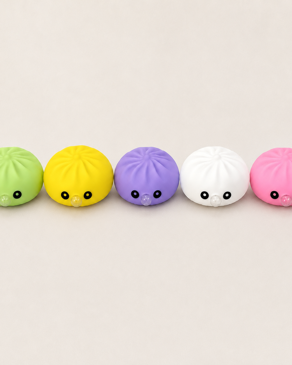 a mystery dumpling-shaped squishy fidget with assorted surprise colors, a soft sensory feel, and a bubble-blowing mouth detail