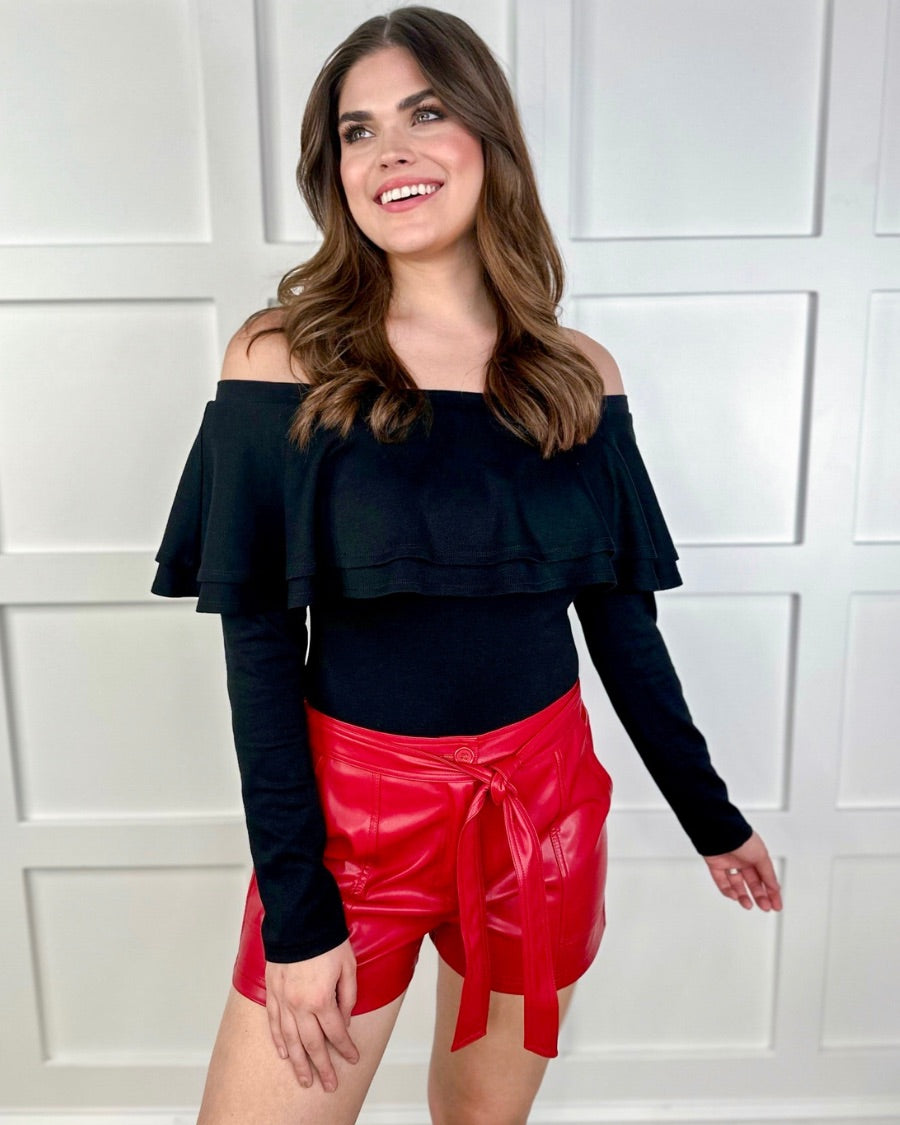 sleek faux leather shorts with zip and button closure, side pockets, a non-removable tie detail, and an elastic back waistband in red