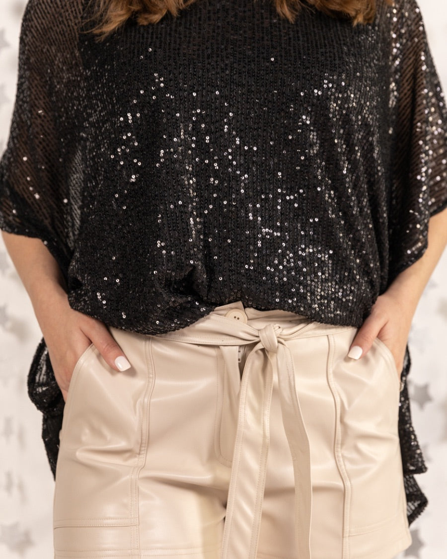 sleek faux leather shorts with zip and button closure, side pockets, a non-removable tie detail, and an elastic back waistband in taupe