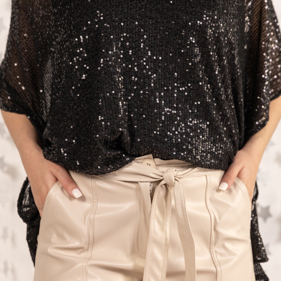 sleek faux leather shorts with zip and button closure, side pockets, a non-removable tie detail, and an elastic back waistband in taupe