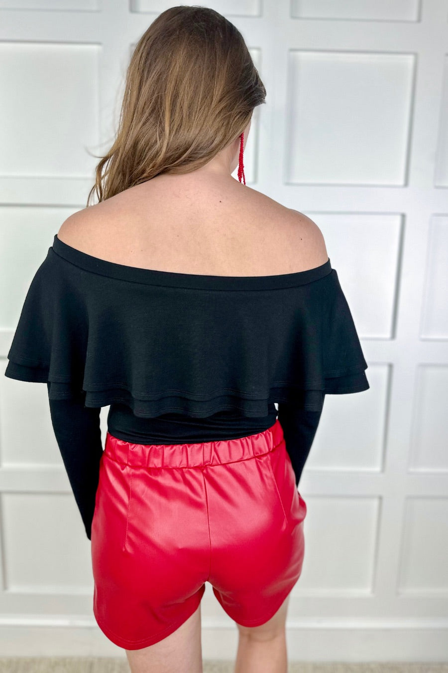 sleek faux leather shorts with zip and button closure, side pockets, a non-removable tie detail, and an elastic back waistband in red