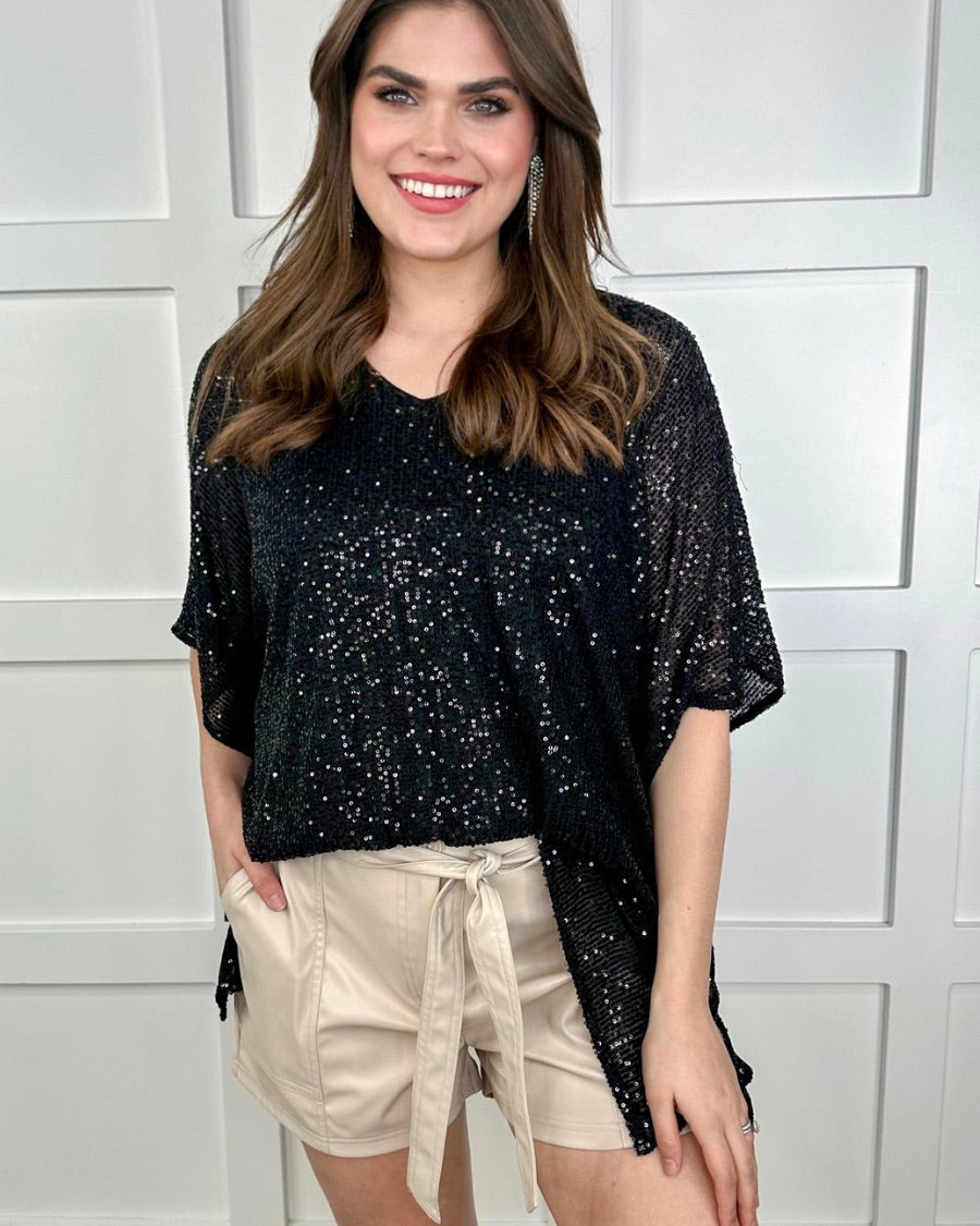 sleek faux leather shorts with zip and button closure, side pockets, a non-removable tie detail, and an elastic back waistband in taupe