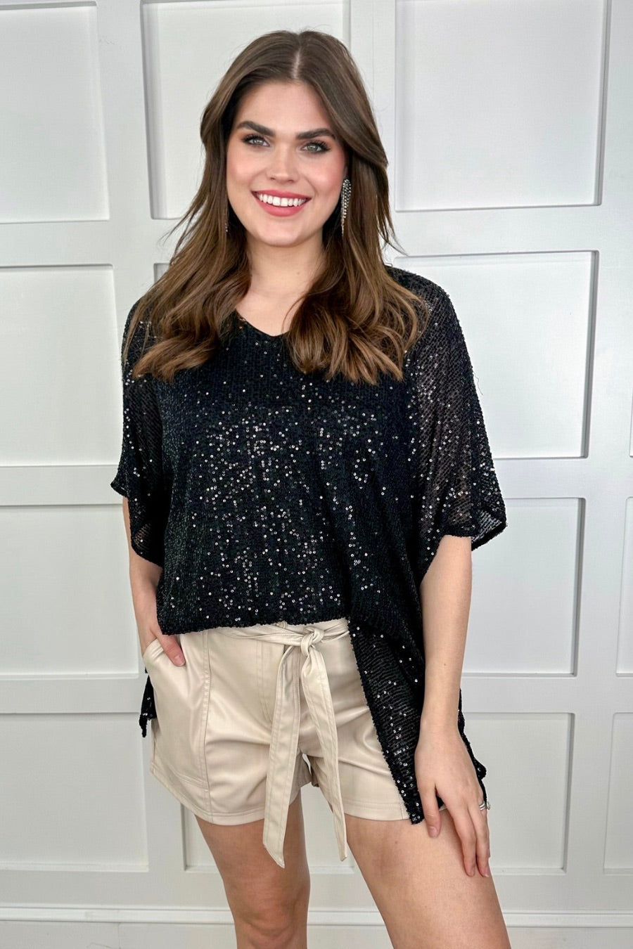 sleek faux leather shorts with zip and button closure, side pockets, a non-removable tie detail, and an elastic back waistband in taupe