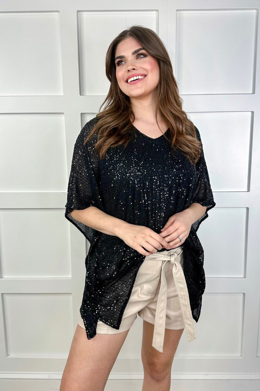 sleek faux leather shorts with zip and button closure, side pockets, a non-removable tie detail, and an elastic back waistband in taupe