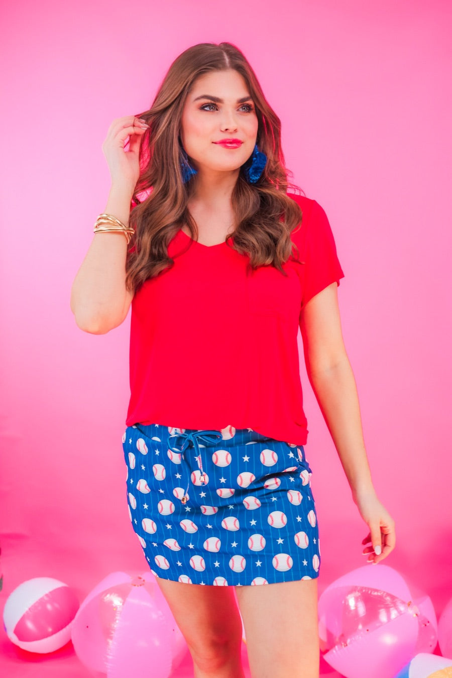 mid-relaxed fit everyday skort made of lightweight material with built-in ivory shorts, drawstring tie, an elastic band on the back, and side pockets, designed on a baseball pattern print and royal blue base