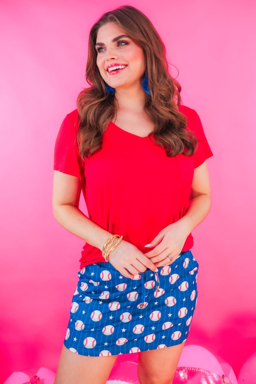 mid-relaxed fit everyday skort made of lightweight material with built-in ivory shorts, drawstring tie, an elastic band on the back, and side pockets, designed on a baseball pattern print and royal blue base