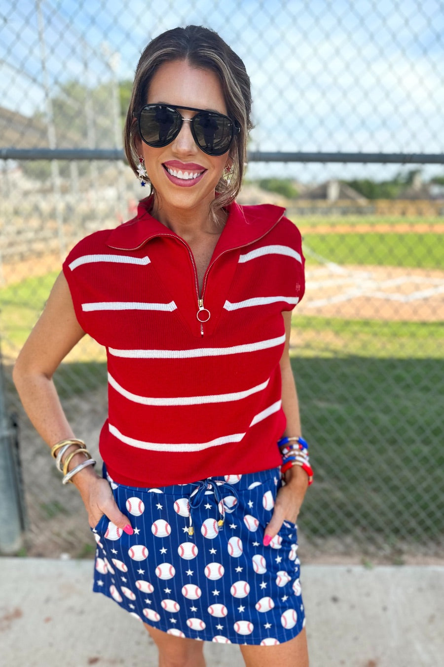 mid-relaxed fit everyday skort made of lightweight material with built-in ivory shorts, drawstring tie, an elastic band on the back, and side pockets, designed on a baseball pattern print and royal blue base