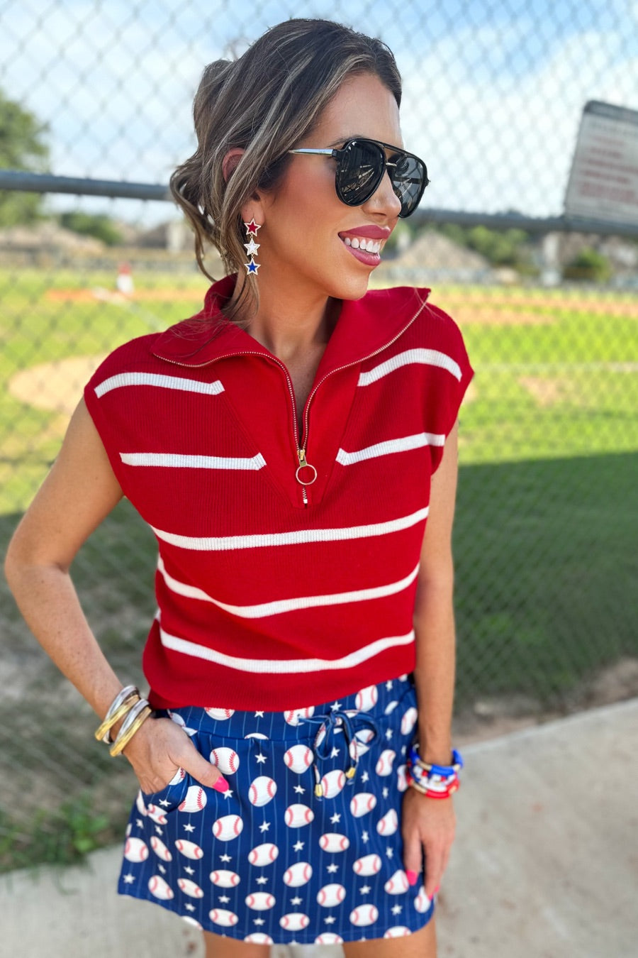 mid-relaxed fit everyday skort made of lightweight material with built-in ivory shorts, drawstring tie, an elastic band on the back, and side pockets, designed on a baseball pattern print and royal blue base