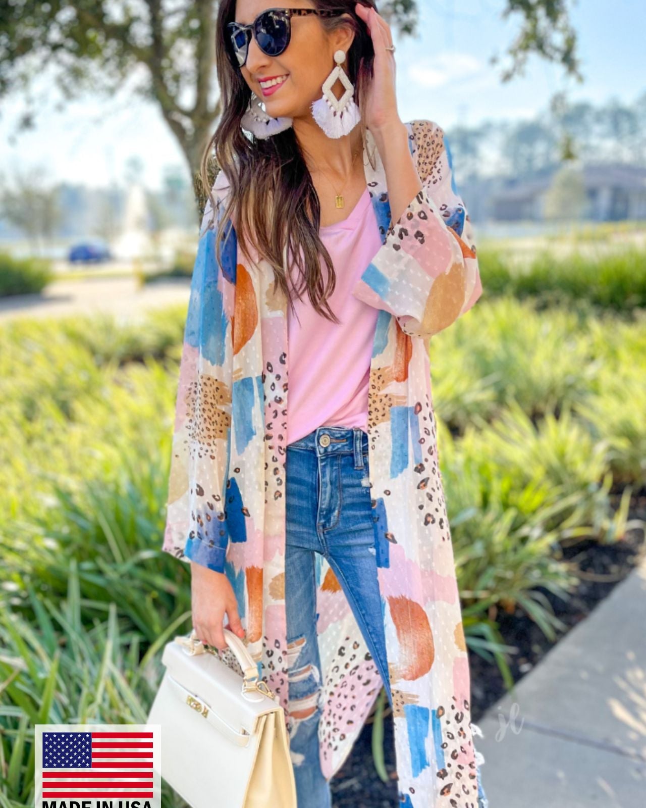 open front kimono made from flowy, lightweight fabric adorned with a striking mix of stripes and animal print motifs in ivory