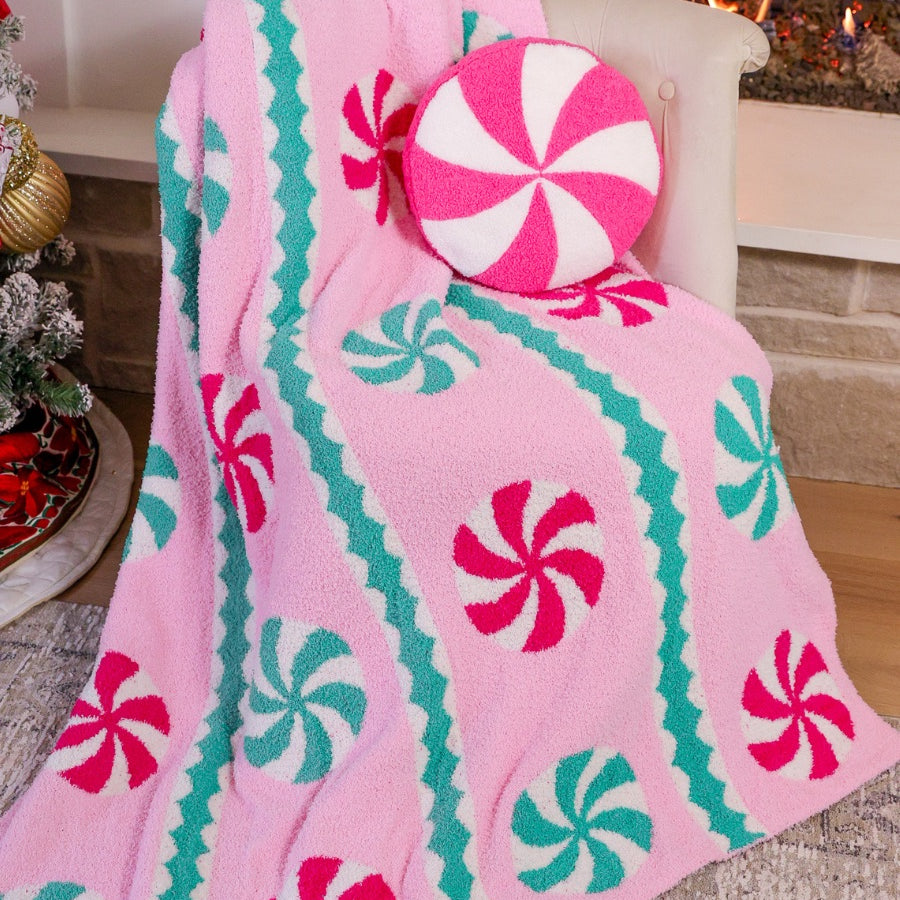 ultra-soft throw on a playful peppermint candy motifs dancing across a cotton candy pink background, framed with whimsical mint green and white scalloped stripes paired with our Pink Peppermint Pillow