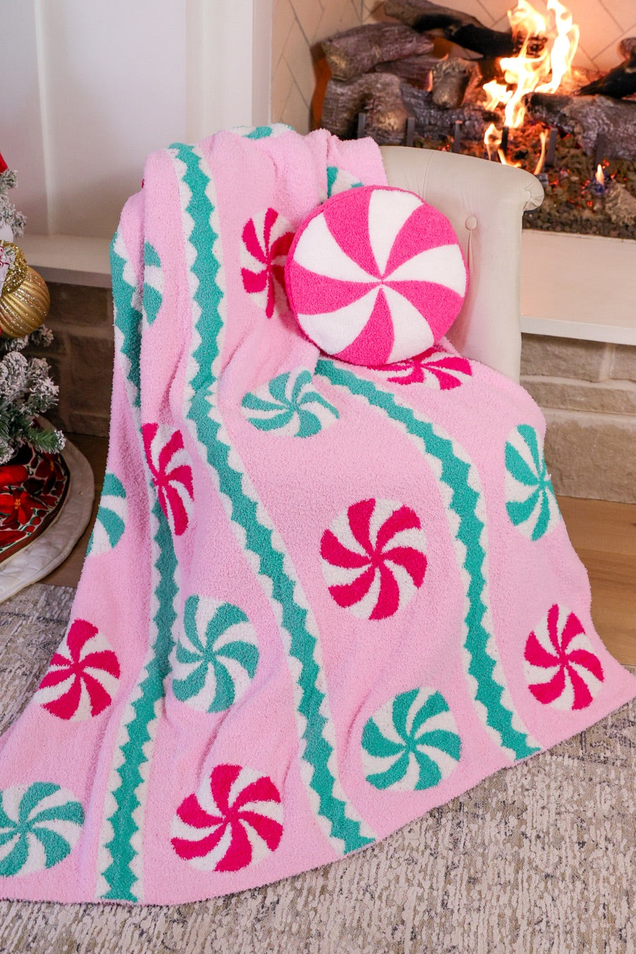 ultra-soft throw on a playful peppermint candy motifs dancing across a cotton candy pink background, framed with whimsical mint green and white scalloped stripes paired with our Pink Peppermint Pillow
