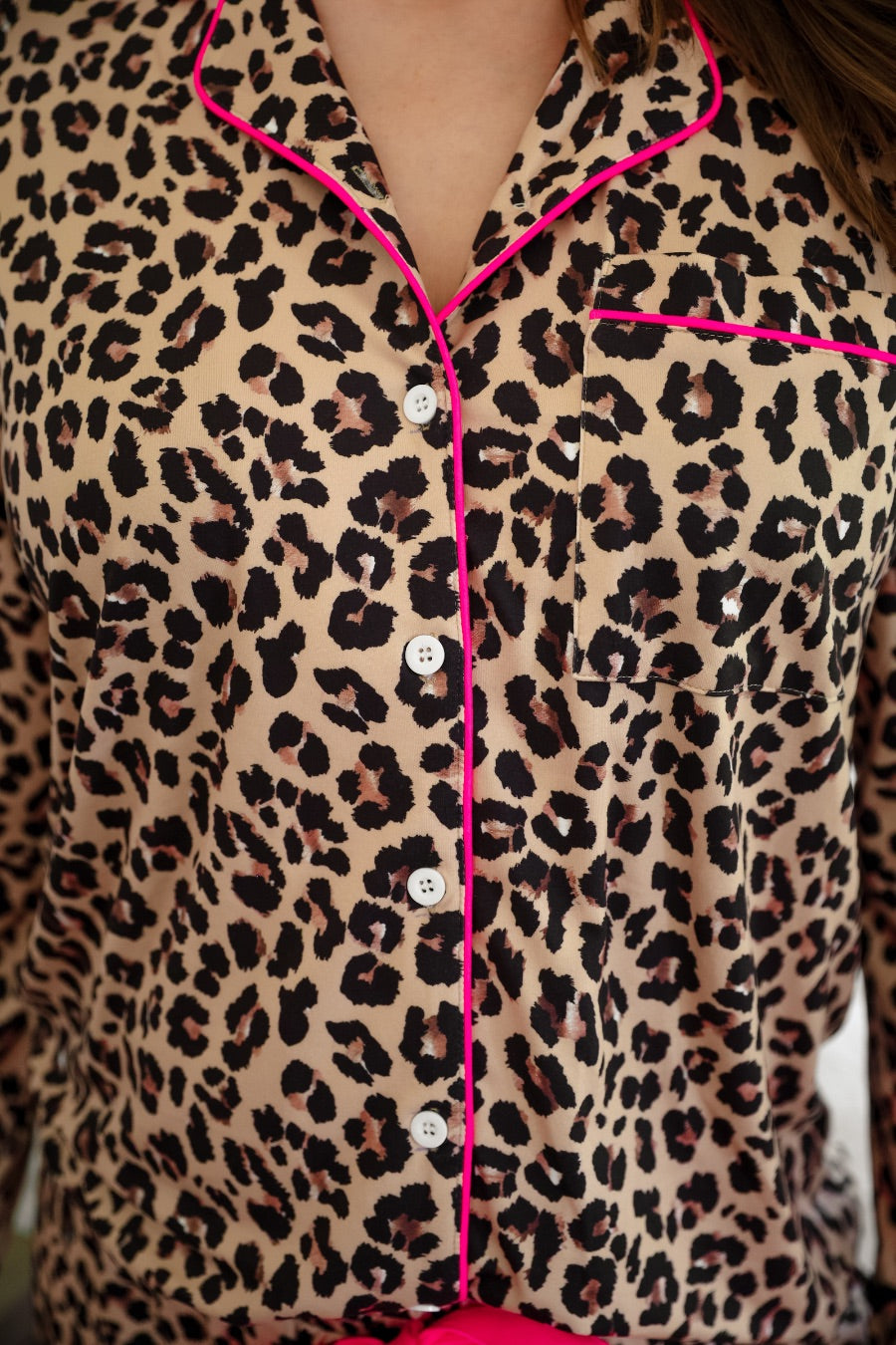 long sleeve top and matching shorts on a brown leopard fabric with hot pink accents