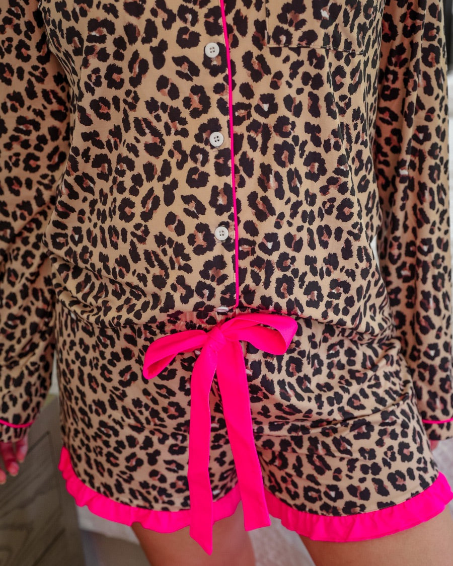long sleeve top and matching shorts on a brown leopard fabric with hot pink accents