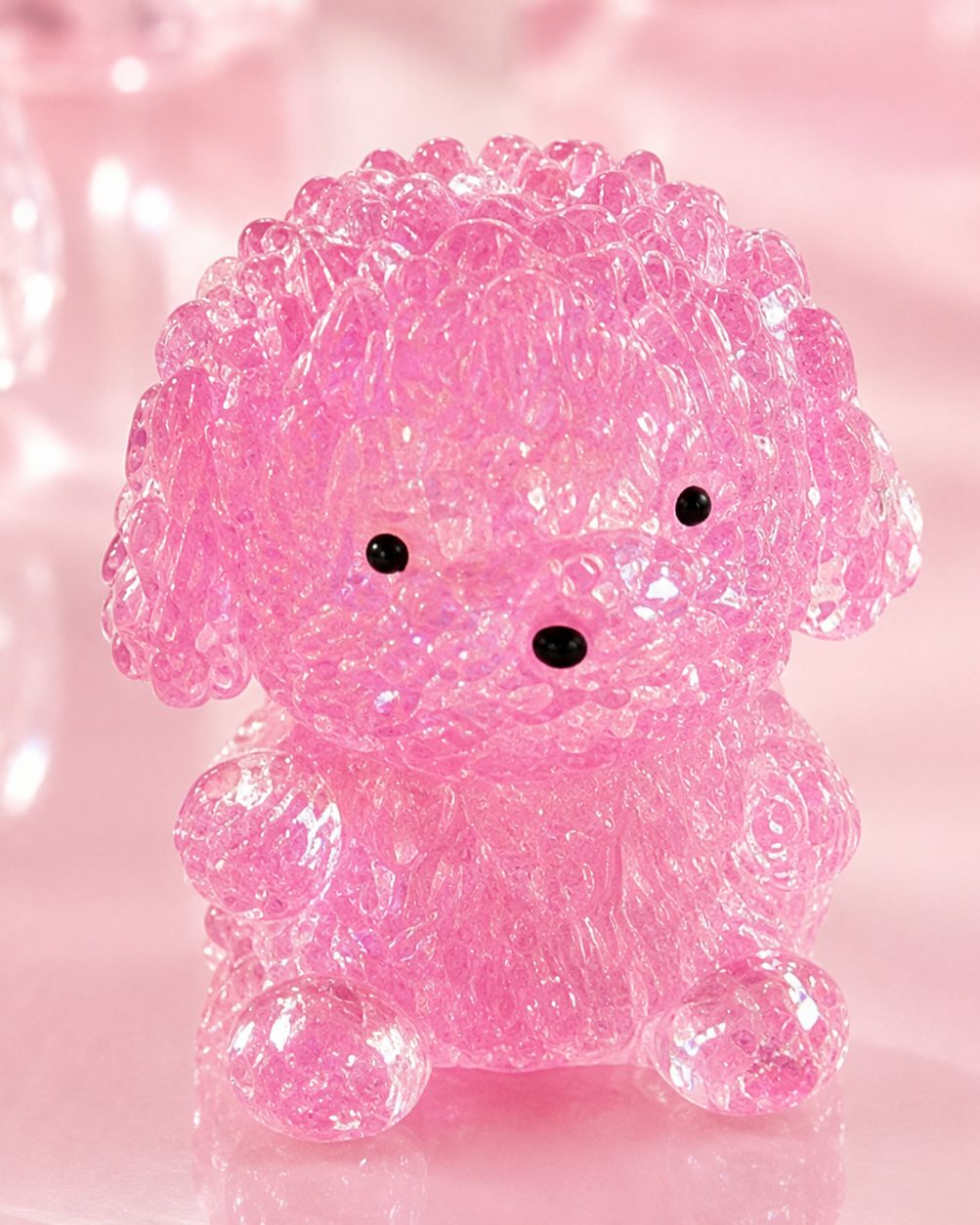 a pink gel-filled puppy-shaped squishy with a translucent crystal-like texture, assorted colors, tiny face details, and a soft handheld design