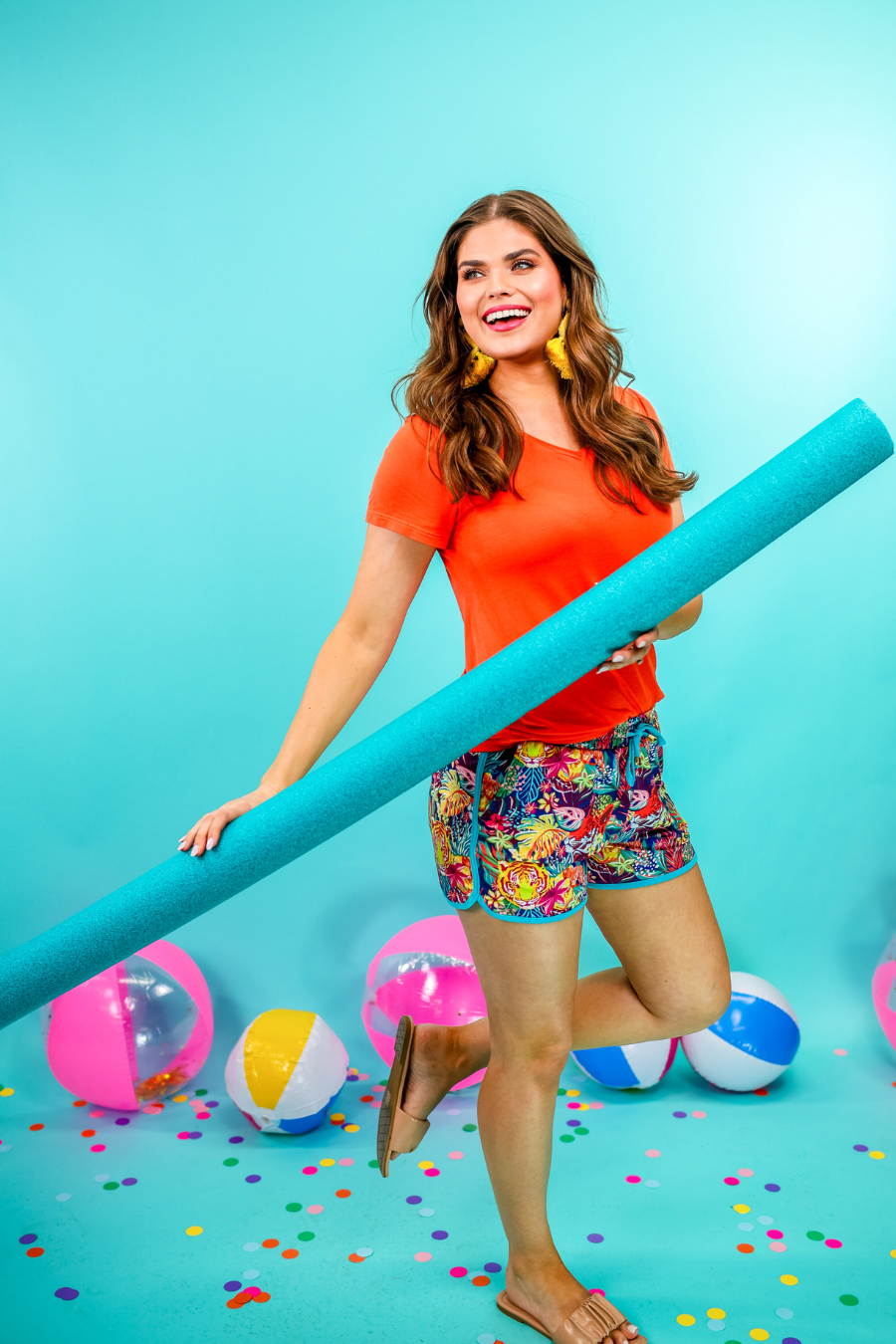 mid-rise relaxed fit activewear shorts with side pockets and a tie waist drawstring with gold bead accents, designed on a vibrant wild cat and jungle pattern print fabric, navy base, and turquoise trim