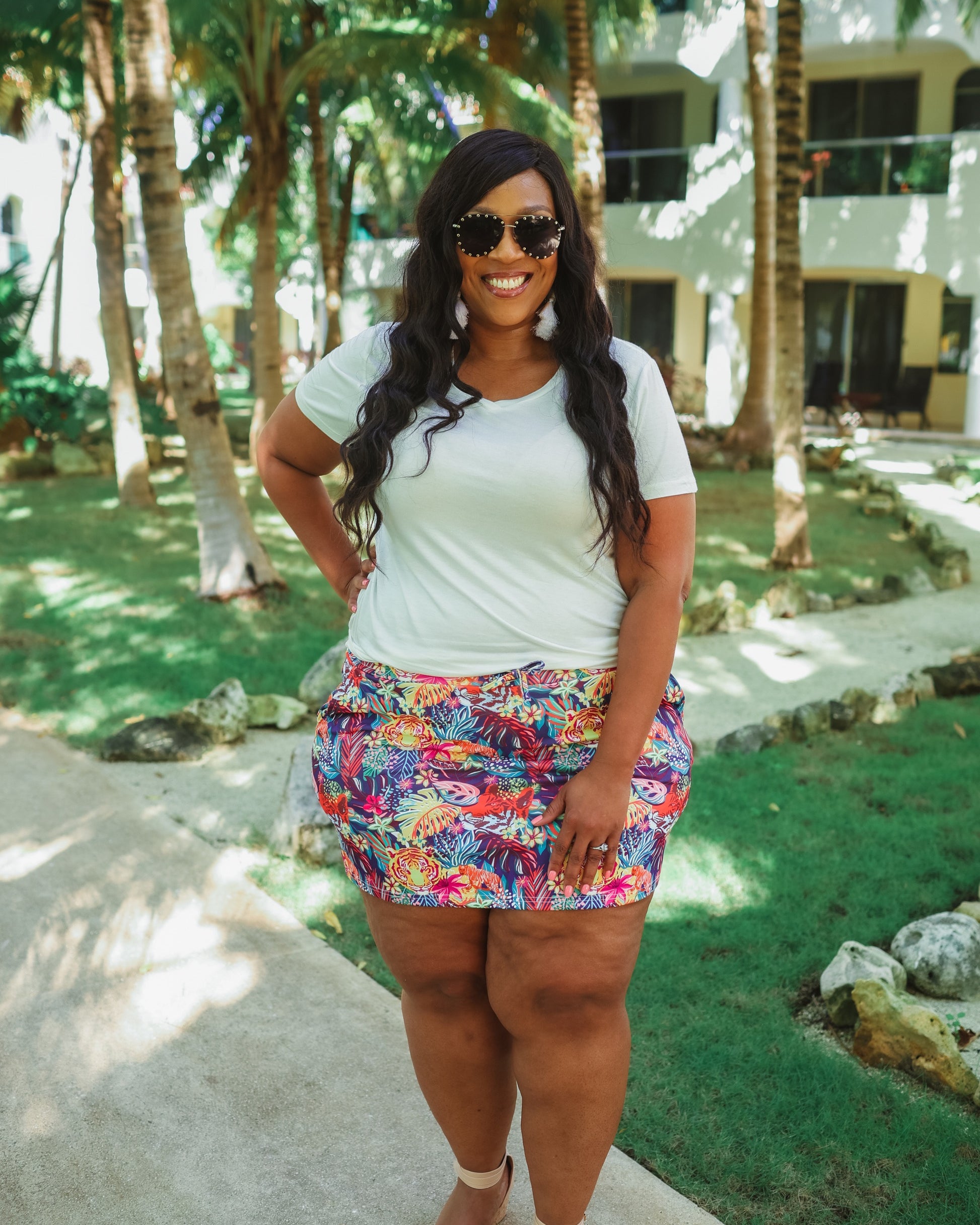 mid-rise relaxed fit everyday skort made of lightweight material with built-in ivory shorts, drawstring tie, an elastic band on the back, and side pockets, designed on a vibrant wild cat and jungle pattern print fabric and navy base