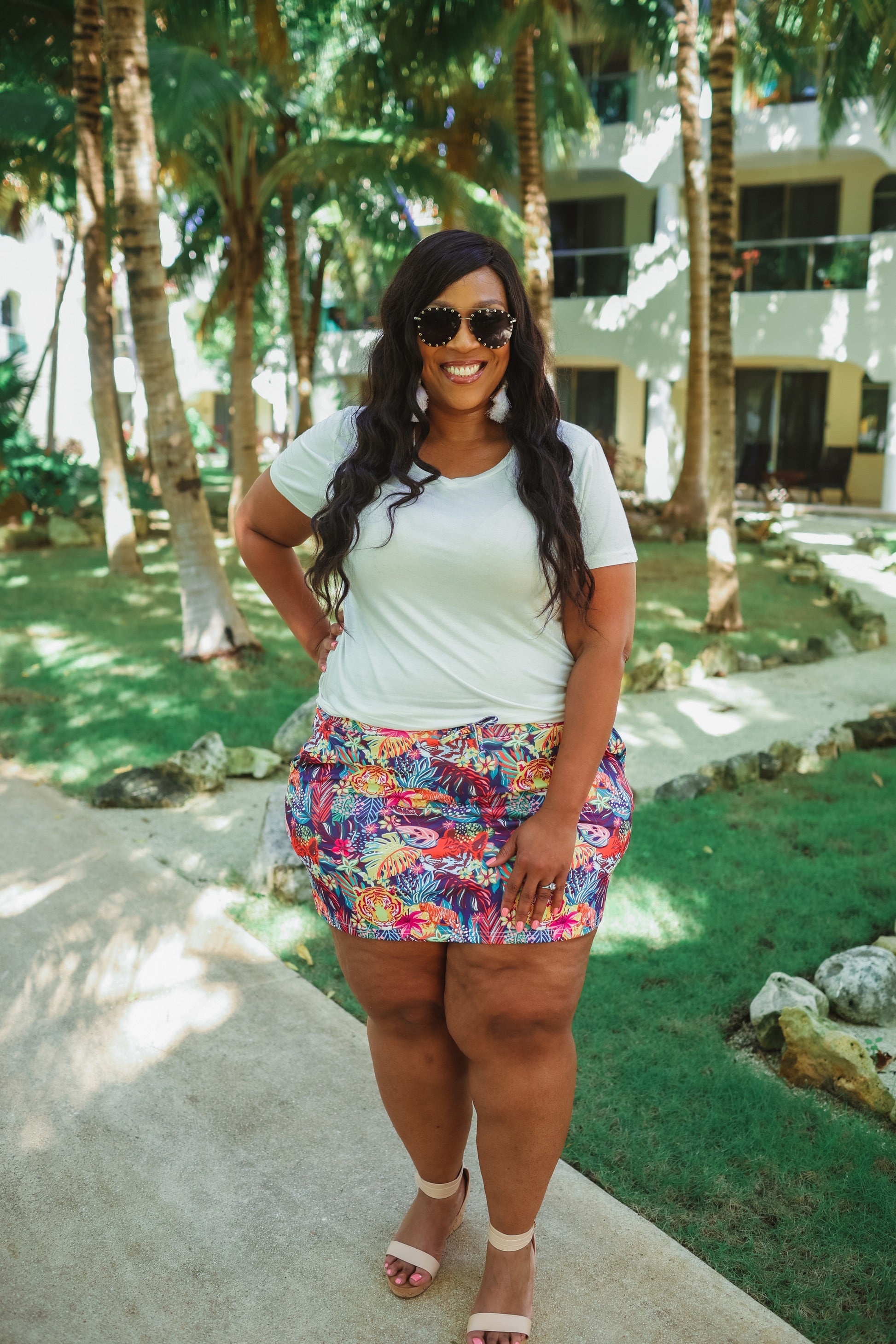 mid-rise relaxed fit everyday skort made of lightweight material with built-in ivory shorts, drawstring tie, an elastic band on the back, and side pockets, designed on a vibrant wild cat and jungle pattern print fabric and navy base