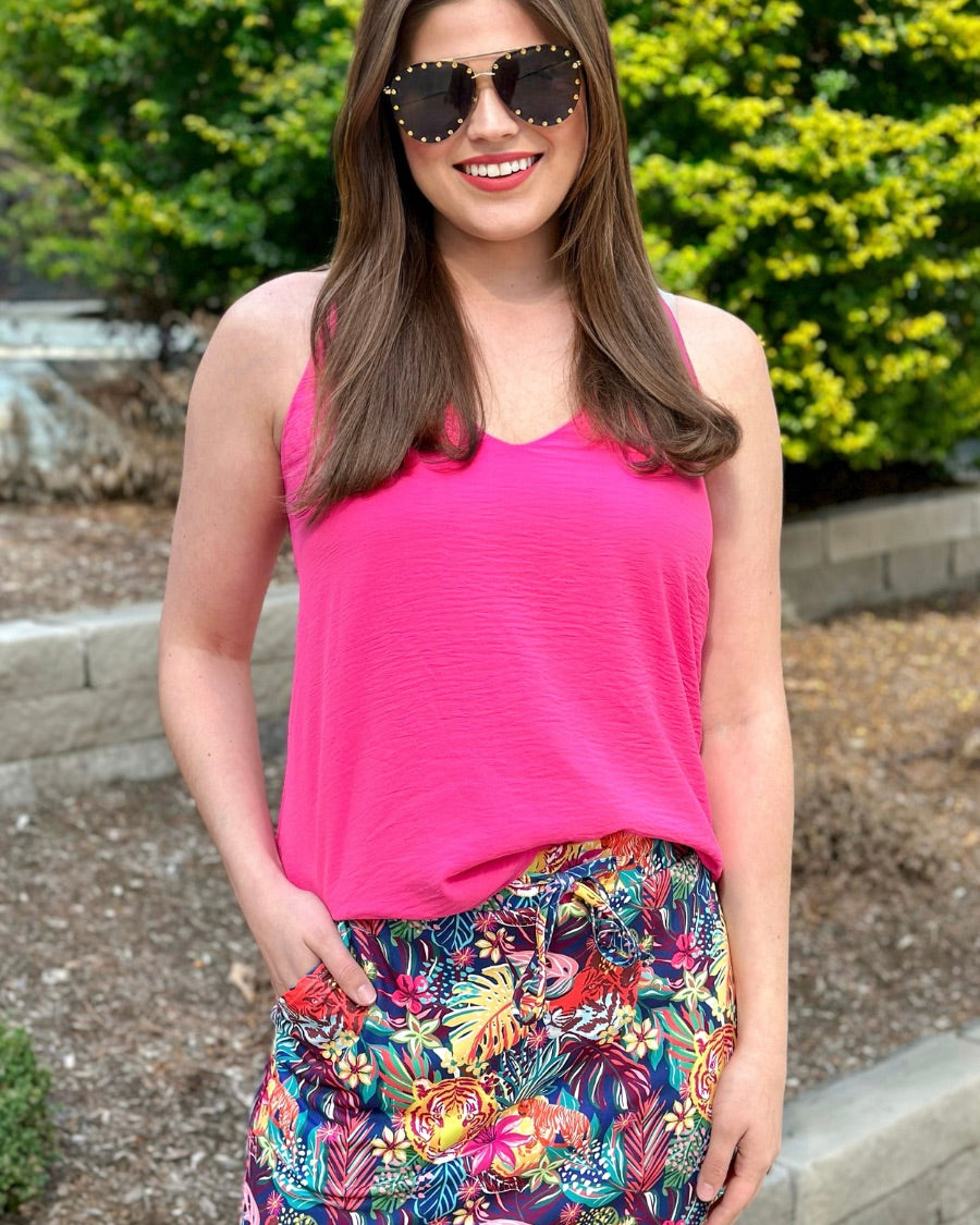 mid-rise relaxed fit everyday skort made of lightweight material with built-in ivory shorts, drawstring tie, an elastic band on the back, and side pockets, designed on a vibrant wild cat and jungle pattern print fabric and navy base