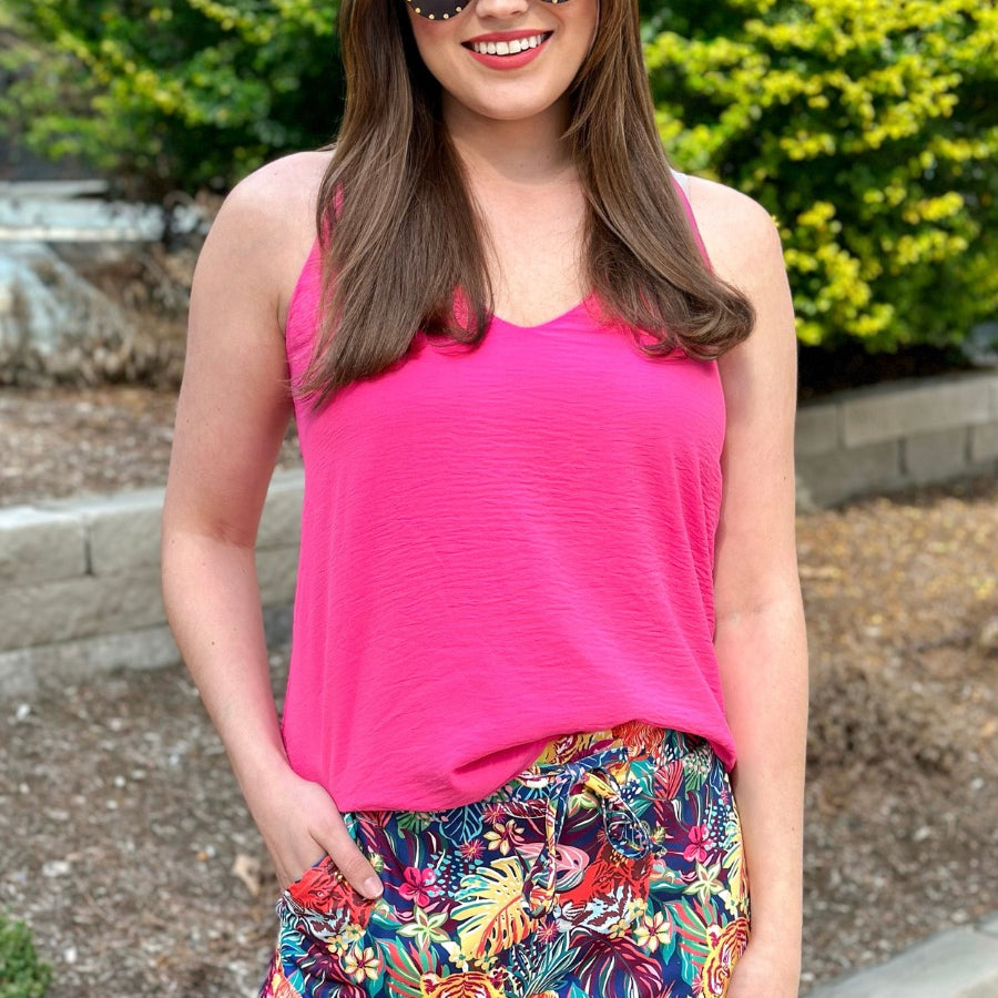 mid-rise relaxed fit everyday skort made of lightweight material with built-in ivory shorts, drawstring tie, an elastic band on the back, and side pockets, designed on a vibrant wild cat and jungle pattern print fabric and navy base