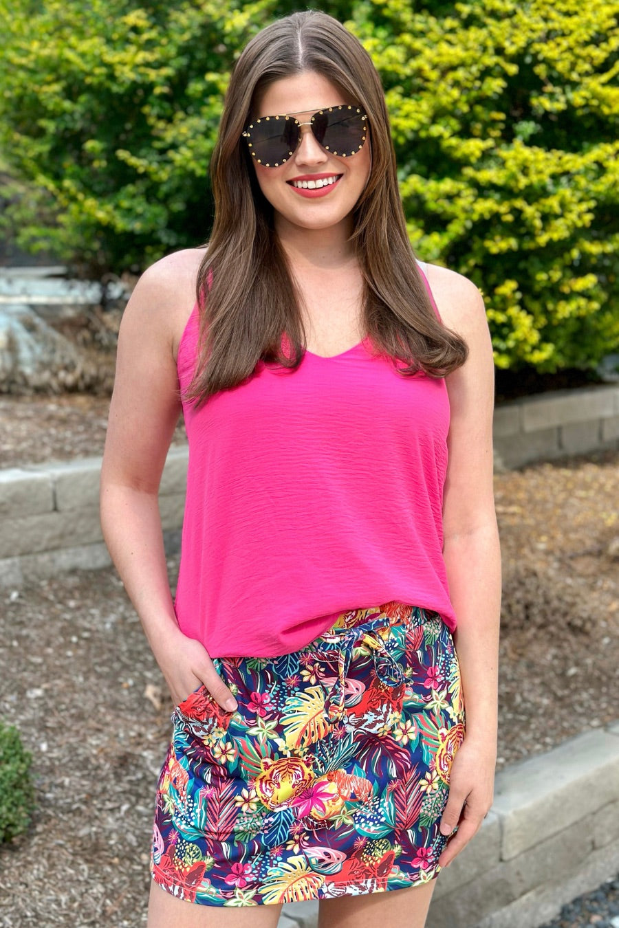 mid-rise relaxed fit everyday skort made of lightweight material with built-in ivory shorts, drawstring tie, an elastic band on the back, and side pockets, designed on a vibrant wild cat and jungle pattern print fabric and navy base